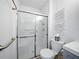 Bathroom showcasing a shower with glass doors and a nearby toilet at 35149 Wagner Way, Zephyrhills, FL 33541