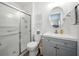 Bathroom features a vanity with gray cabinets, toilet, and a glass-enclosed shower at 35149 Wagner Way, Zephyrhills, FL 33541