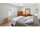 Sunlit bedroom with wood floors, ceiling fan, and ample closet space at 35149 Wagner Way, Zephyrhills, FL 33541
