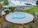 Inviting spa located near the community pool and clubhouse, surrounded by mature landscaping and seating at 35149 Wagner Way, Zephyrhills, FL 33541