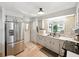 A well lit kitchen features stainless steel appliances, neutral countertops, and tiled backsplash at 35149 Wagner Way, Zephyrhills, FL 33541