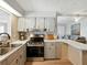 A modern kitchen features stainless steel oven, neutral countertops, and tiled backsplash at 35149 Wagner Way, Zephyrhills, FL 33541