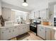 A well lit kitchen features stainless steel oven, neutral countertops, and tiled backsplash at 35149 Wagner Way, Zephyrhills, FL 33541