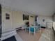 Enclosed patio featuring a table with four chairs, a TV, and ample lighting at 35149 Wagner Way, Zephyrhills, FL 33541