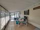 Enclosed patio space with a table, chairs, TV, and access to the outdoors at 35149 Wagner Way, Zephyrhills, FL 33541
