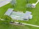 View of the community shuffleboard area with covered seating, set amidst well-maintained landscaping at 35149 Wagner Way, Zephyrhills, FL 33541