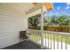Covered back porch with chair overlooking fenced yard and lawn at 3806 N Tampa St, Tampa, FL 33603