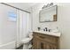 Charming bathroom featuring a vanity with a light wood finish, subway tile walls, and patterned tile floor at 3806 N Tampa St, Tampa, FL 33603