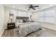 Cozy bedroom featuring a ceiling fan, wood-look floors, neutral walls, and bright, natural light at 3806 N Tampa St, Tampa, FL 33603