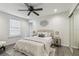 Comfortable bedroom featuring a closet with mirrored doors, a ceiling fan, and bedside tables at 3806 N Tampa St, Tampa, FL 33603