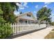 Charming home with a white picket fence, beautiful green plants, and inviting curb appeal at 3806 N Tampa St, Tampa, FL 33603