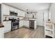 Clean, white kitchen with stainless steel appliances, butcher block countertops, and wood-look floors at 3806 N Tampa St, Tampa, FL 33603