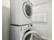 White stacked LG washer and dryer with window for natural light. and tile floor at 3806 N Tampa St, Tampa, FL 33603