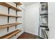 Walk in storage closet with wood shelves and ample storage space at 3806 N Tampa St, Tampa, FL 33603