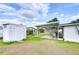 Backyard featuring a shed, covered patio with outdoor seating, and well-maintained lawn at 39423 9Th Ave, Zephyrhills, FL 33542