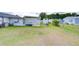 The home features a spacious backyard with a patio, an outbuilding, and a white picket fence at 39423 9Th Ave, Zephyrhills, FL 33542
