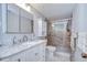Bathroom features marble countertop vanity, mirrored medicine cabinet, and glass door shower at 39423 9Th Ave, Zephyrhills, FL 33542