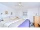 Bright bedroom features two windows, ceiling fan, and well-maintained hardwood furnishings at 39423 9Th Ave, Zephyrhills, FL 33542