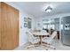 Cozy dining area featuring a round table and chairs, tile floors, and ample lighting at 39423 9Th Ave, Zephyrhills, FL 33542