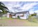 Charming single-story home with a brick facade, one-car garage, and white horizontal siding at 39423 9Th Ave, Zephyrhills, FL 33542