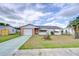 Charming single-story home with a brick facade, one-car garage, and well-maintained front yard at 39423 9Th Ave, Zephyrhills, FL 33542