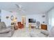 Cozy living room featuring comfortable seating, fan, and a neutral color palette at 39423 9Th Ave, Zephyrhills, FL 33542