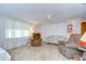 Inviting living room with large window, tiled flooring, and comfortable seating at 39423 9Th Ave, Zephyrhills, FL 33542