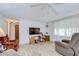 Relaxing living room with TV, ceiling fan, tile floors, and lots of natural light at 39423 9Th Ave, Zephyrhills, FL 33542