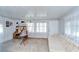 A bonus living space with a bright window and a vintage couch and desk against a white backdrop at 39423 9Th Ave, Zephyrhills, FL 33542