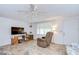 This comfortable living room offers tile floors, a ceiling fan, and lots of light at 39423 9Th Ave, Zephyrhills, FL 33542