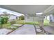 Covered patio features a dining table with seating and view of the backyard at 39423 9Th Ave, Zephyrhills, FL 33542