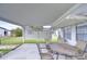This covered patio offers a shady space with table and seating, perfect for relaxing at 39423 9Th Ave, Zephyrhills, FL 33542