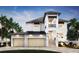 Beautiful new construction home with a light exterior, two car garage, second story balcony, and manicured landscaping at 4 W Spanish Main St, Tampa, FL 33609