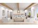 Bright, open-concept living room with wooden beams, neutral furniture, and direct access to the kitchen and backyard at 4 W Spanish Main St, Tampa, FL 33609
