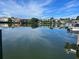 Beautiful waterfront view featuring multiple luxury homes and a dockside boat at 4 W Spanish Main St, Tampa, FL 33609