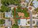 Aerial view of the property showcasing its location on a corner lot, surrounded by lush greenery and mature trees at 4465 1St Ne Way, St Petersburg, FL 33703