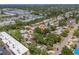 Aerial view of a neighborhood featuring tree-lined streets, well-maintained homes, and community tennis courts at 4465 1St Ne Way, St Petersburg, FL 33703