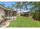 Spacious backyard featuring well-manicured lawn, lush landscaping, shed for storage, and screened porch at 4465 1St Ne Way, St Petersburg, FL 33703