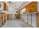 Kitchen features studs, concrete block, terrazzo floor, wooden cabinets, and a window at 4465 1St Ne Way, St Petersburg, FL 33703