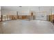 Spacious living room with studs, concrete block, and a terrazzo floor undergoing renovation at 4465 1St Ne Way, St Petersburg, FL 33703