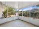 Enclosed patio with concrete floor, screened windows overlooking mature backyard landscaping, great for relaxing outdoors at 4465 1St Ne Way, St Petersburg, FL 33703