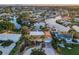 This elevated view of the property features lush landscaping, a brick driveway, and two-car garage at 4772 Dover Ne St, St Petersburg, FL 33703