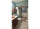 Cozy bathroom featuring custom vanity, a tub with shower, and a window, providing a comfortable and functional space at 4772 Dover Ne St, St Petersburg, FL 33703