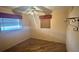 Bright bedroom with wood-look flooring, two windows, and ceiling fan providing a cozy space at 4772 Dover Ne St, St Petersburg, FL 33703