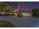 Charming exterior view of a well-maintained home, featuring a spacious driveway, attached garage and tropical landscaping at 4772 Dover Ne St, St Petersburg, FL 33703