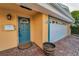 Close-up showcasing the front door and garage of the tan home with brick pavers at 4772 Dover Ne St, St Petersburg, FL 33703