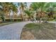 View of the home showcasing its lush landscaping and unique, curved brick driveway at 4772 Dover Ne St, St Petersburg, FL 33703