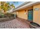 Home's entrance with brick pavers, a bright blue door, and well-maintained landscaping at 4772 Dover Ne St, St Petersburg, FL 33703