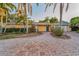 Charming single-story home with a brick driveway and beautiful tropical landscaping at 4772 Dover Ne St, St Petersburg, FL 33703