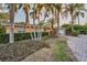 Inviting single-story home with vibrant landscaping, palm trees, and a brick paved driveway at 4772 Dover Ne St, St Petersburg, FL 33703